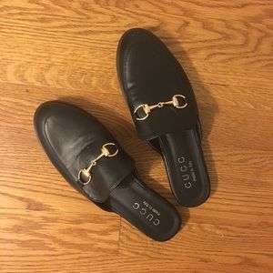 Black mules with gold clasp